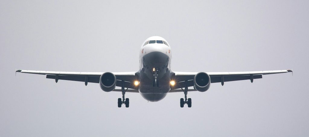 pexels photo 358319 358319 A commercial airliner captured head-on, preparing to land against a cloudy sky.
